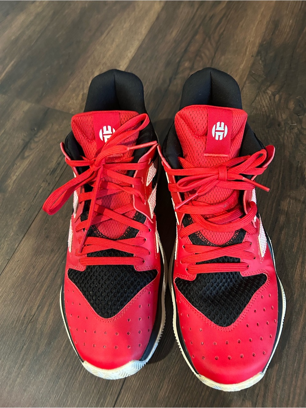 Adidas Harden Stepback basketball sneakers in a vibrant scarlet red colorway.